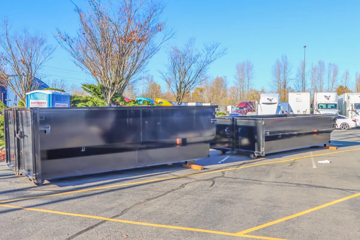 Professional dumpster rental service with roll-off container on residential driveway in Tullahoma